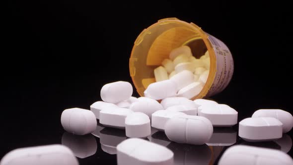 Moving over top of prescription opioid drugs on black table