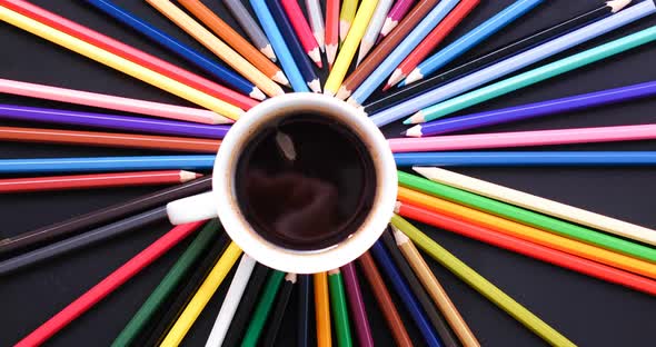 top view stop motion a coffee cup and pencil colorful on black background.