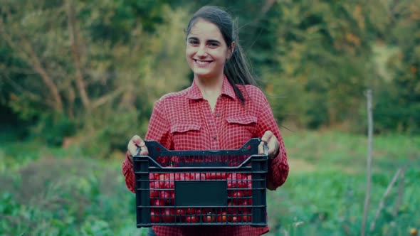 Young caucasian woman farmer stands in a field