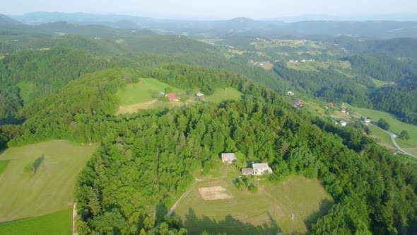 Green countryside with hills and lots of small farming ranches all over the place. Aerial 4k view.