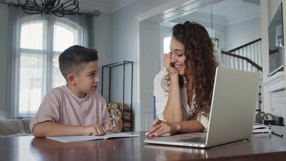 Young Mother And Son At The Table