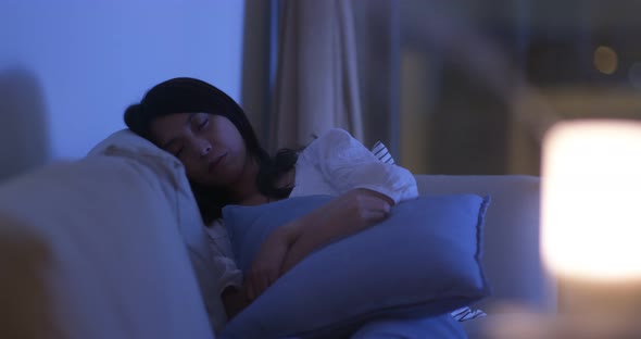 Woman Sleep on Sofa at Night