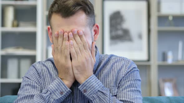 Adult Man Upset by Loss while Working in Office