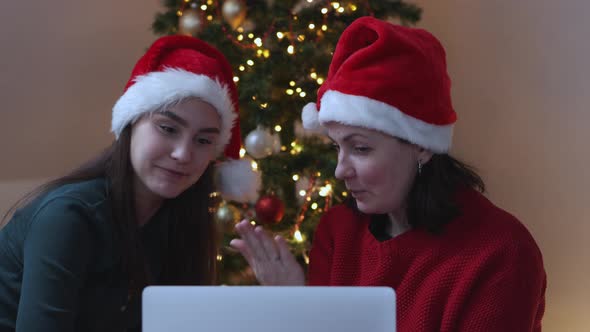 Two Female Red Santa Hats Talking Video Call Using Laptop Christmas New Year