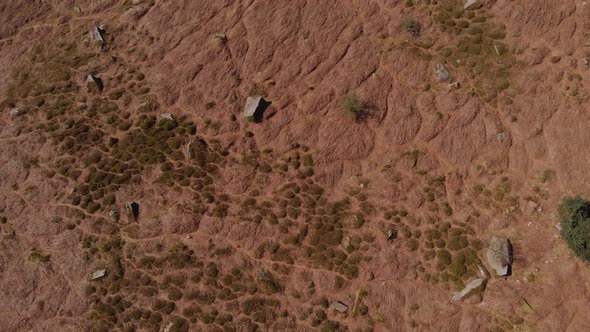 Drone aerial birds eye view face down shot of Bamford Edge ground textures travelling towards a near