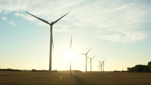 Wind Turbines in a Field on a Beautiful Sunset Aerial View