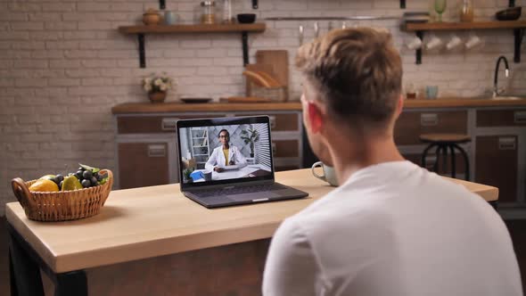 Sick Man Consulting with Woman Doctor Via Internet