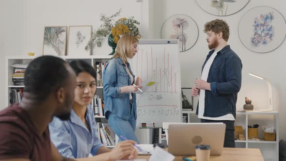 Serious Female Manager Executive and Diverse Team People Analyze Paperwork Talk Work Together Gather