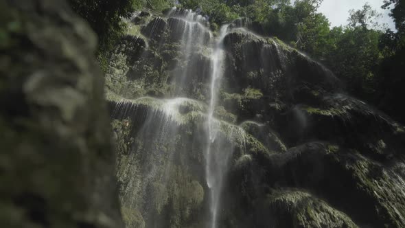 Slow reveal of Tumalog falls with foreground elements.