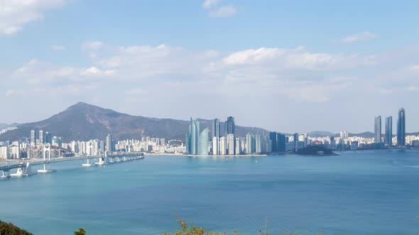 Timelapse Ocean Bay with Cloud Shadows Against Busan City