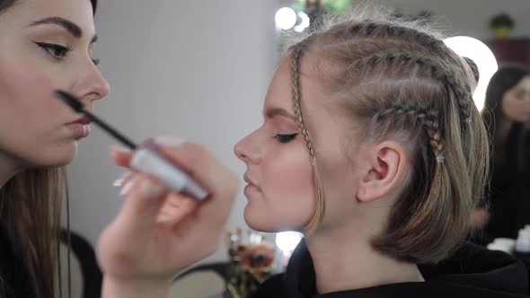 Side View of Make Up Artist Work with Beautiful Blond Hair Model