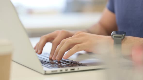 Close Up of Male Hands Typing on Laptop