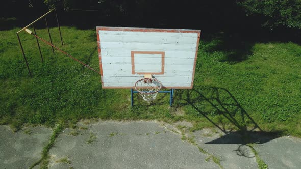 Old Basketball Backboard. Made From Boards. Peeling Paint And A Battered Basket
