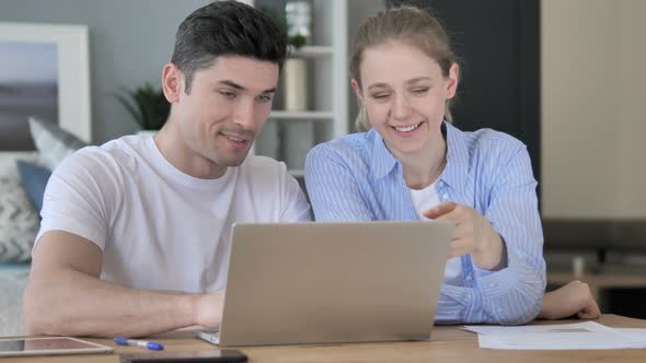 Young Designers Discussing Project on Laptop