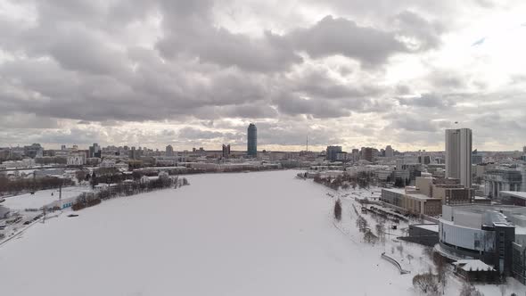 Aerial view of frozen river in big winter city 10