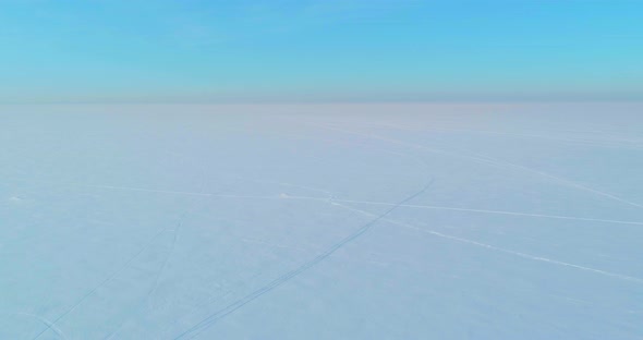 Aerial View of Cold Winter Landscape Arctic Field Trees Covered with Frost Snow Ice River and Sun