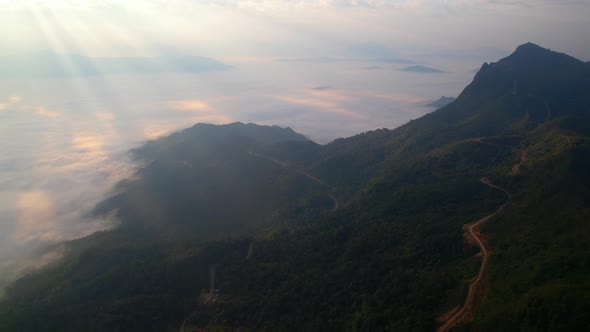 Aerial view from drone, Epic sunbeam over clouds mountains. 4K aerial shot on sunrise