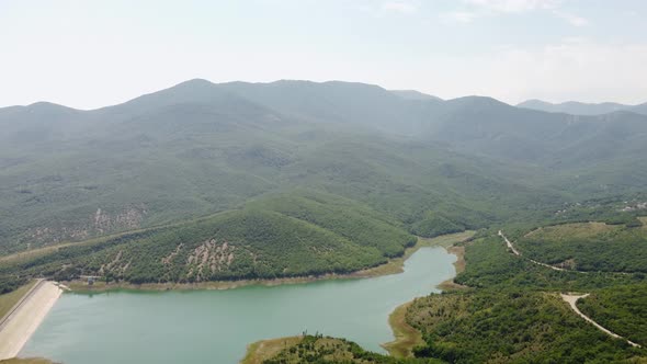 Mountains in Greenery and a Lake View From the Air