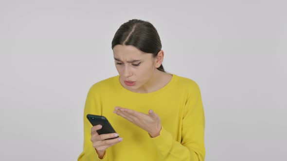 Spanish Woman Reacting to Loss on Smartphone on White Background