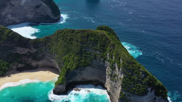  Kelingking beach, Nusa Penida, Bali, Indonesia. Aerial view at sea and rocks.