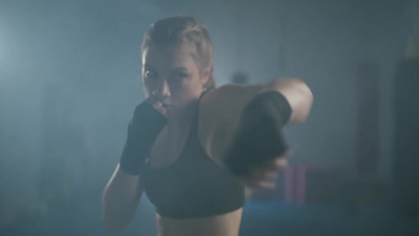 Young Woman Fighter Trains His Punches Training in the Boxing Gym Female Trains a Series of Punches
