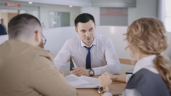 A Married Couple Signs a Contract for the Sale of a New Car