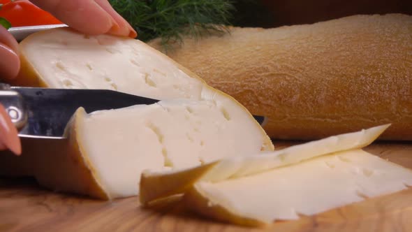 Knife Cuts Off a Piece of Soft Sheep's Cheese