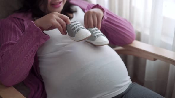 Happy Pregnant Woman and Expecting Baby at Home