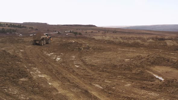 Yellow Large Dump Truck at a Copper Mine in the Top View