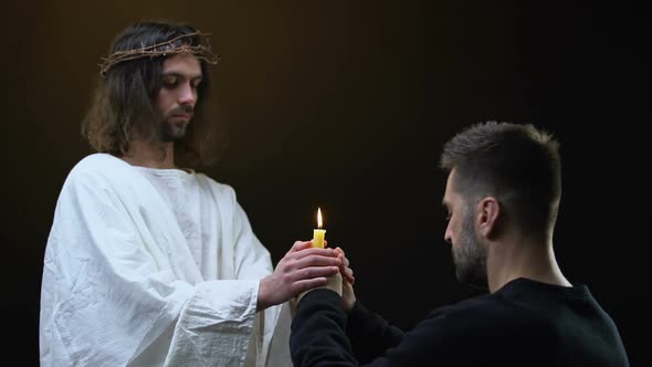 Male Parishioner and Jesus Praying Holding Burning Candle Together, Faith Symbol