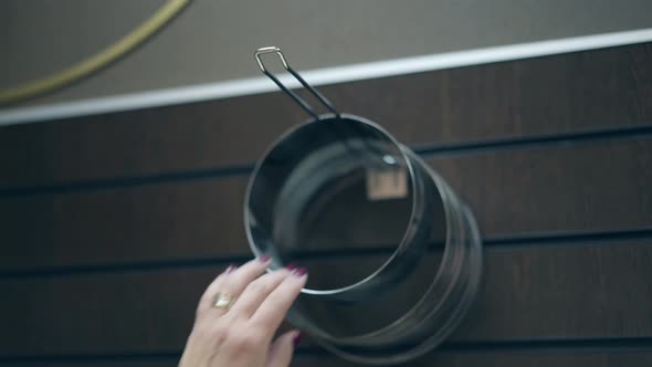Woman Takes Baking Forms Hanging on Kitchen Organizer