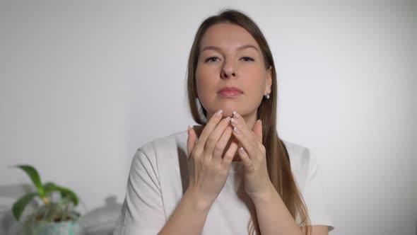 A Young Woman Looks in the Mirror