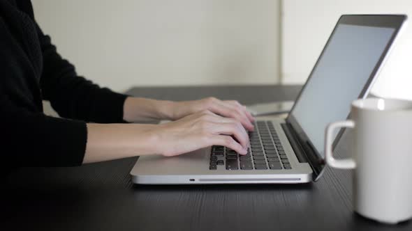 Woman Working On Computer In Office