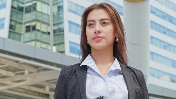 Asian young smart businesswoman working in company and confident standing outdoor office in city.