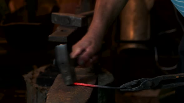Blacksmith Forges Hot Iron in the Forge