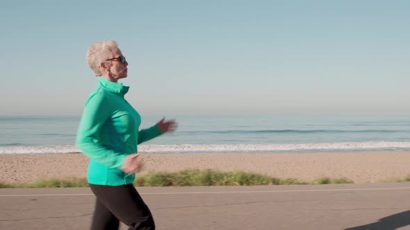 Senior Woman Exercising At The  Beach