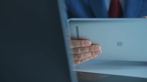 Businessman Sitting In Office And Using Digital Tablet.