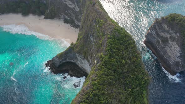 Aerial Shot of Water Sparkling From the Sun's Reflection and Tourists on the White Sand Beach