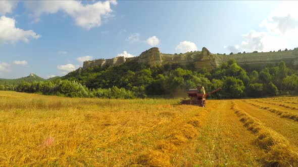 Combine Harvesting Grains At Picturesque Place