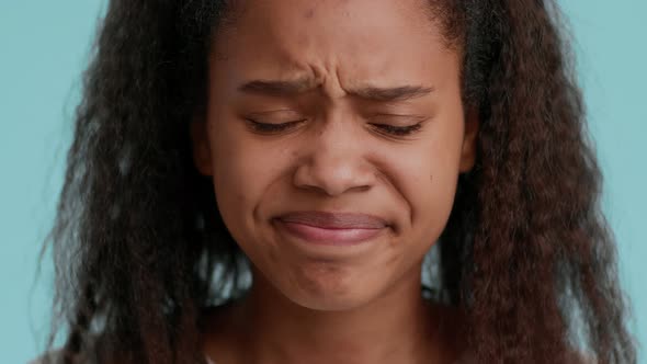 Unhappy Black Teenager Girl Crying Looking At Camera Blue Background