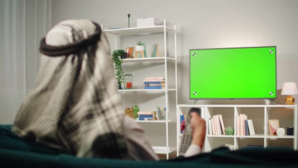 Middle Eastern Man Watching Tv with Chroma Key Closeup alt