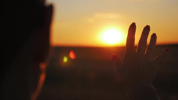 Back View Silhouette Lonely Woman Trying to Touch the Sun