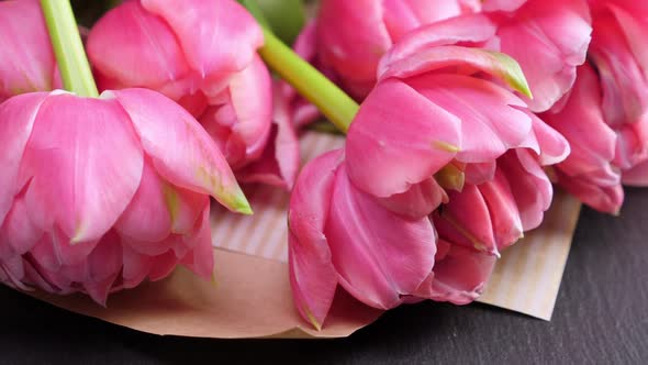 Pink Tulips in Kraft Paper on Black Background