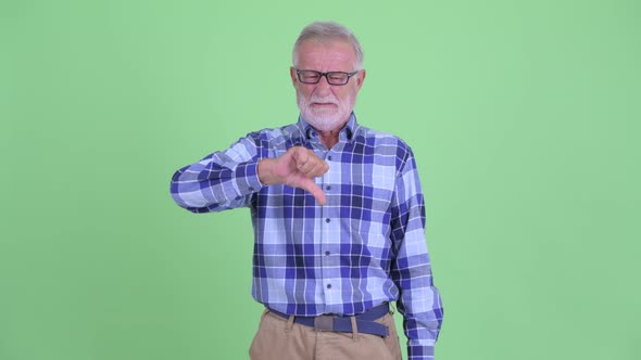 Stressed Senior Bearded Hipster Man Giving Thumbs Down