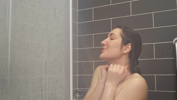 Brunette with Bare Torso Sings Dances Under Relaxing Shower