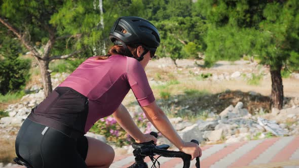 Cyclist riding on road bike in city park and getting ready for triathlon