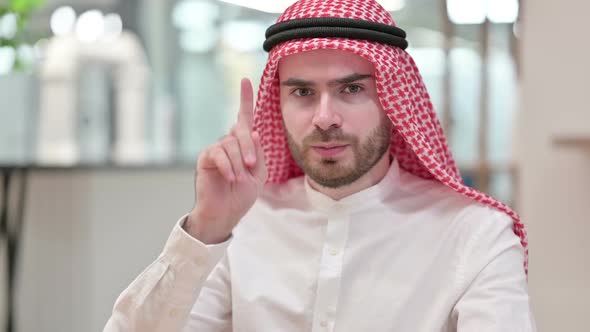 Serious Arab Businessman Saying No By Finger Sign in Office