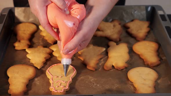 Unrecognizable Woman Decorates Cookies with Icing