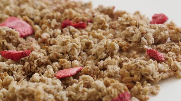 Close-up of dried strawberries in muesli breakfast 4K 2160p 30fps UltraHD panning footage - Pile of 