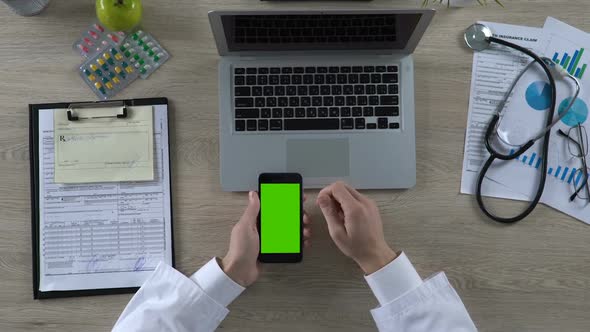 Doctor Hands Scrolling Phone With Green Screen Looking for Drugs in Pharmacy App